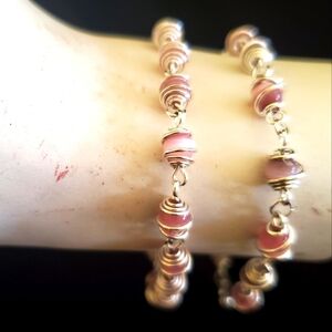 Two silver with pink pearl stones